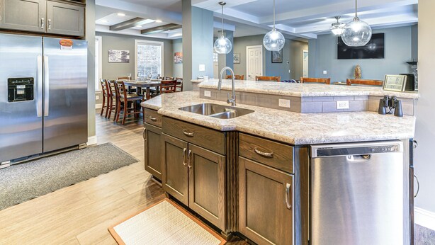 A modern kitchen with a stainless steel refrigerator, a built-in dishwasher, and a granite countertop. - Mountain Views & Brook Access: Home in Arkville! (Arkville)