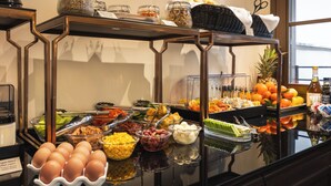 A buffet with various food items including eggs, fruits, and condiments. - Bh Hotel Dimora D'epoca (Rome)