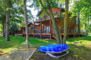 A wooden cabin with a balcony, surrounded by trees. - Short Drive to Itasca State Park - Waterfront Home (Park Rapids)