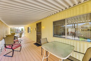 Relax in this serene outdoor space with a long table and comfortable seating.