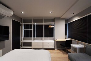 A modern bedroom with a bed, a desk with a chair, a wardrobe, and a TV. - Real Life Iidabashi 1-bedroom Cozy 3pax Hi-end (Tokyo)