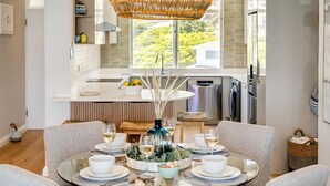 A modern kitchen with a dining area. - Apartment w Sea Views by Camps Bay Beach Kyanos (Cape Town)