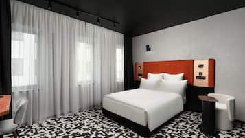 Una habitación de hotel moderna con una cama grande, un escritorio y una silla.