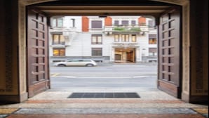 Una puerta abierta que da a una calle con un edificio al fondo.
