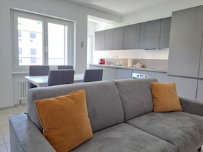Business Condo | Living area | 32-inch flat-screen TV with satellite channels