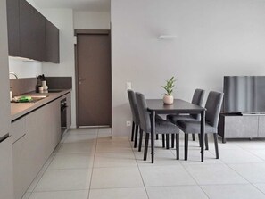 Economy Condo, Balcony | Living area | 32-inch flat-screen TV with satellite channels