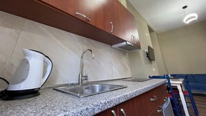 A modern kitchen with granite countertops, stainless steel appliances, and wooden cabinets.