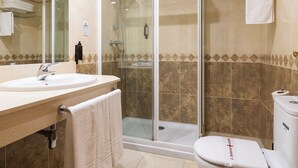 A bathroom with a sink, mirror, shower, and toilet. - HOSTAL LOS VALLES  (Bielsa)