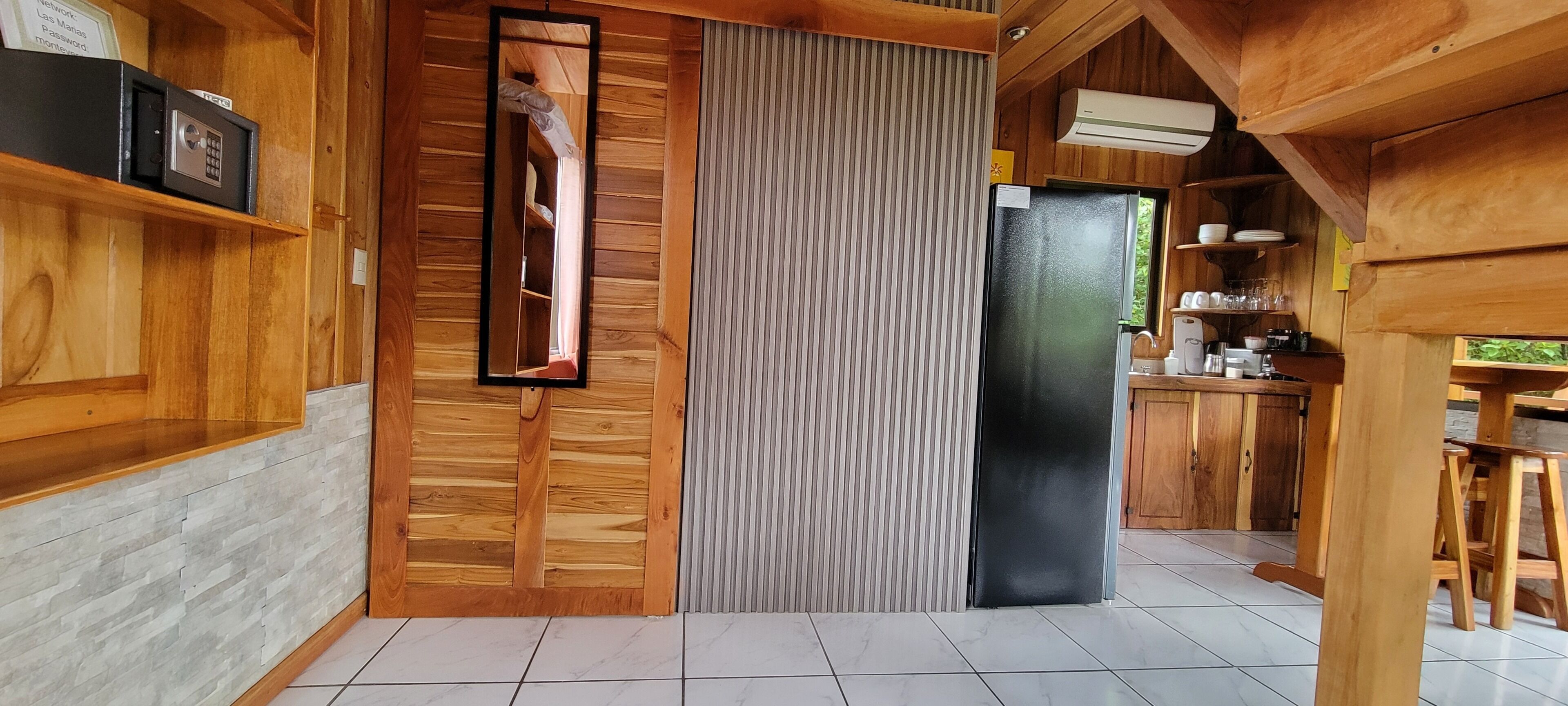 A kitchen with wooden cabinets, a refrigerator, and a countertop with various items.