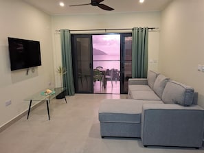 Apartment, Sea View | Living area | Flat-screen TV