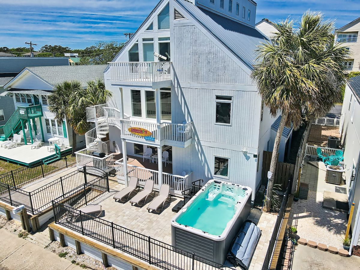 A large house with a pool, outdoor seating, and a sign indicating a restaurant.