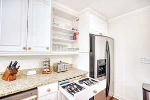 A kitchen with white cabinets, a stainless steel refrigerator, a toaster, and a knife block. - Luxury Home w/ Hottub & Elevator 1Block from Beach (North Myrtle Beach)