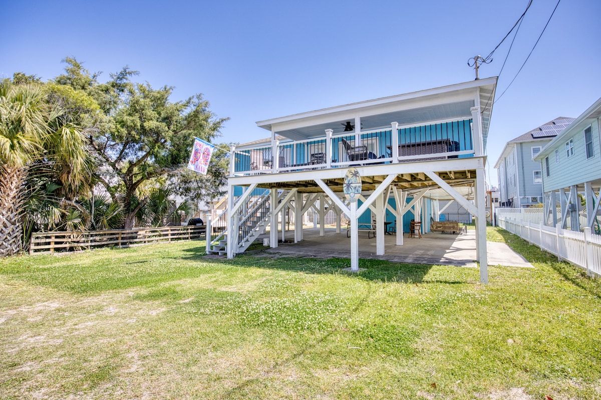 A two-story house with a balcony, a staircase, and a porch area.