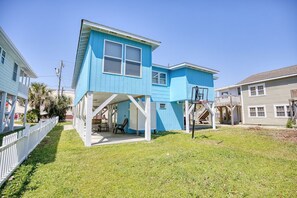 A two-story house with a covered porch and a staircase leading to the upper floor. - 4 BR House in Cherry Grove, 1 Block from beach (North Myrtle Beach)