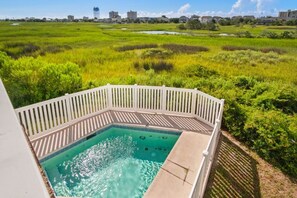 A hot tub with a white deck and a view of a grassy landscape. - 5BR Waterfront Home w/ Pool, hotub, & elevator (North Myrtle Beach)