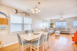 A spacious living room with a dining area, a sofa set, and a ceiling fan. - 6 BR OceanFront w/ Heated Pool/Hottub Cherry Grove (North Myrtle Beach)
