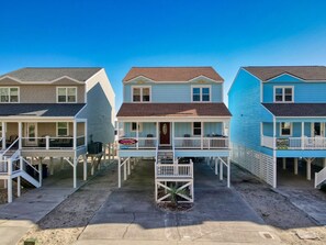 A row of beach houses with a central entrance, each with a porch and outdoor seating. - 6 BR OceanFront w/ Heated Pool/Hottub Cherry Grove (North Myrtle Beach)
