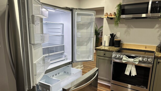 A compact kitchen with a stainless steel refrigerator, an oven, and a microwave. - Winston Salem 3Bd 2Ba GAME ROOM mins to Downtown (Winston-Salem)