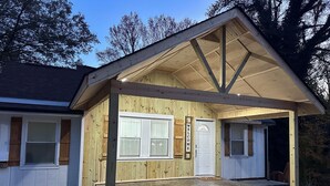 A wooden cabin with a covered porch, a front door, and a 'Welcome' sign. - Winston Salem 3Bd 2Ba GAME ROOM mins to Downtown (Winston-Salem)