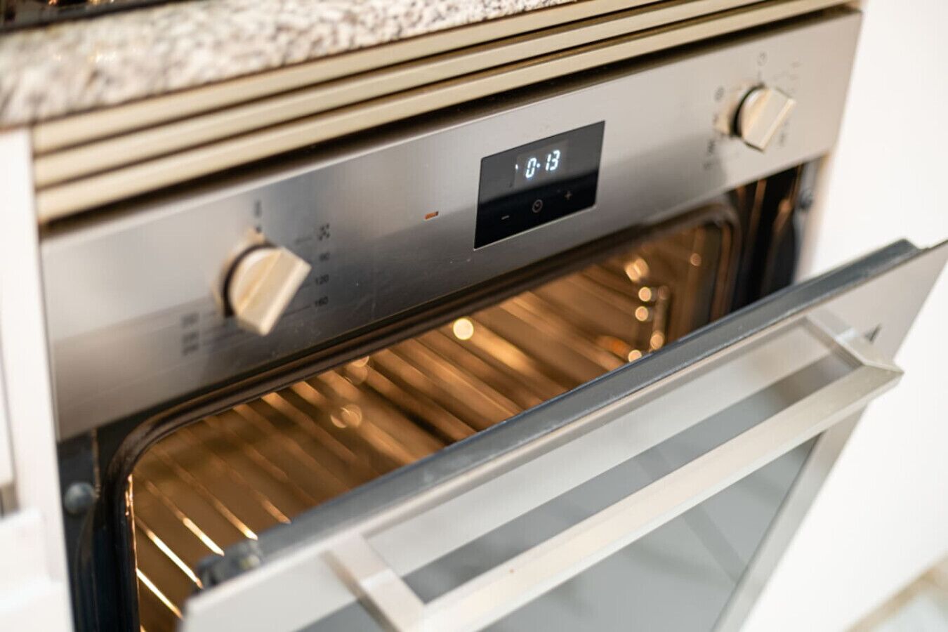 An oven with a digital display showing 0:13.