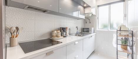 Fridge, microwave, coffee/tea maker, cookware/dishes/utensils