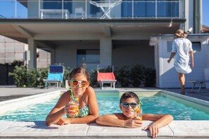 Seasonal outdoor pool, pool loungers