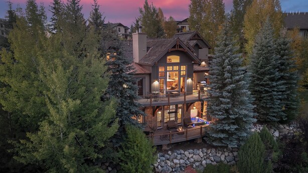 A multi-story house with a balcony, surrounded by trees. - Hot Tub + Close to Skiing – Lariat Ridge Lodge (Steamboat Springs)