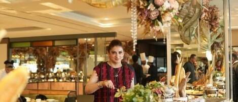 A buffet setup with various food items and a decorative hanging arrangement.