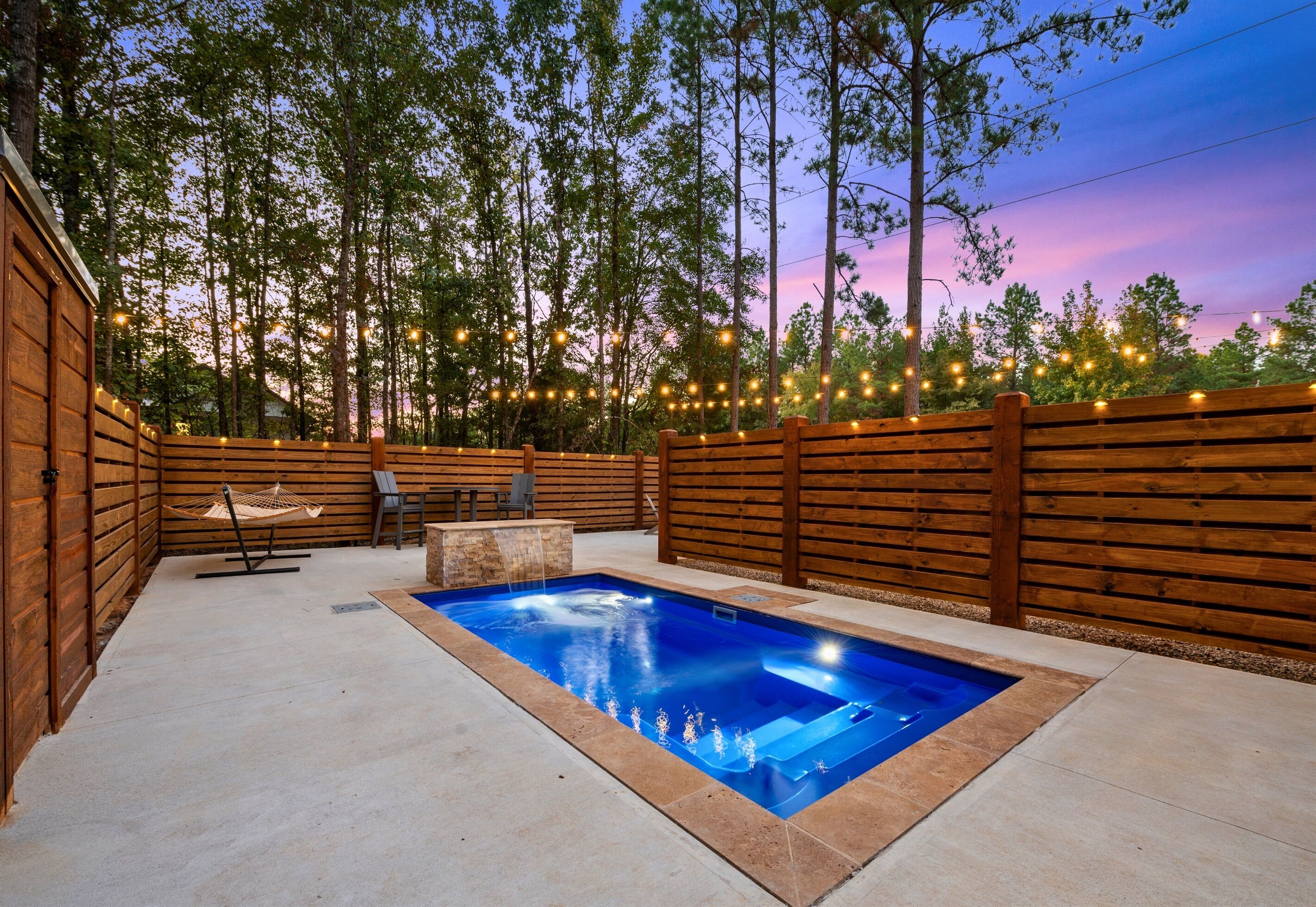 Find your quiet retreat in this beautifully lit outdoor space. The sparkling pool and cozy seating invite you to kick back and enjoy the peaceful surroundings.