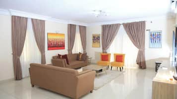 Deluxe Room, Balcony, City View | Living area | TV