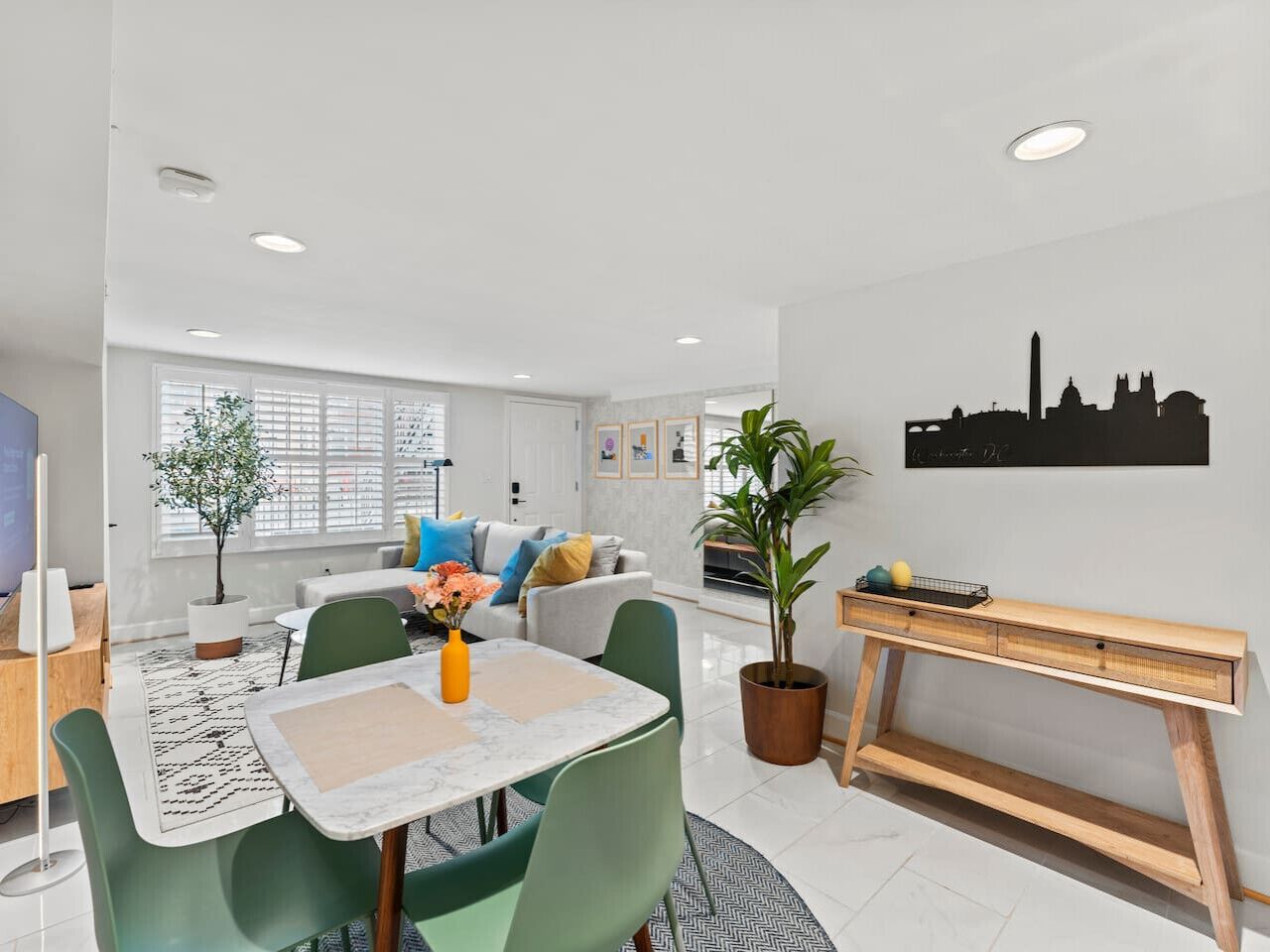 A modern living room with a dining area, a sofa set, a coffee table, and a piano.