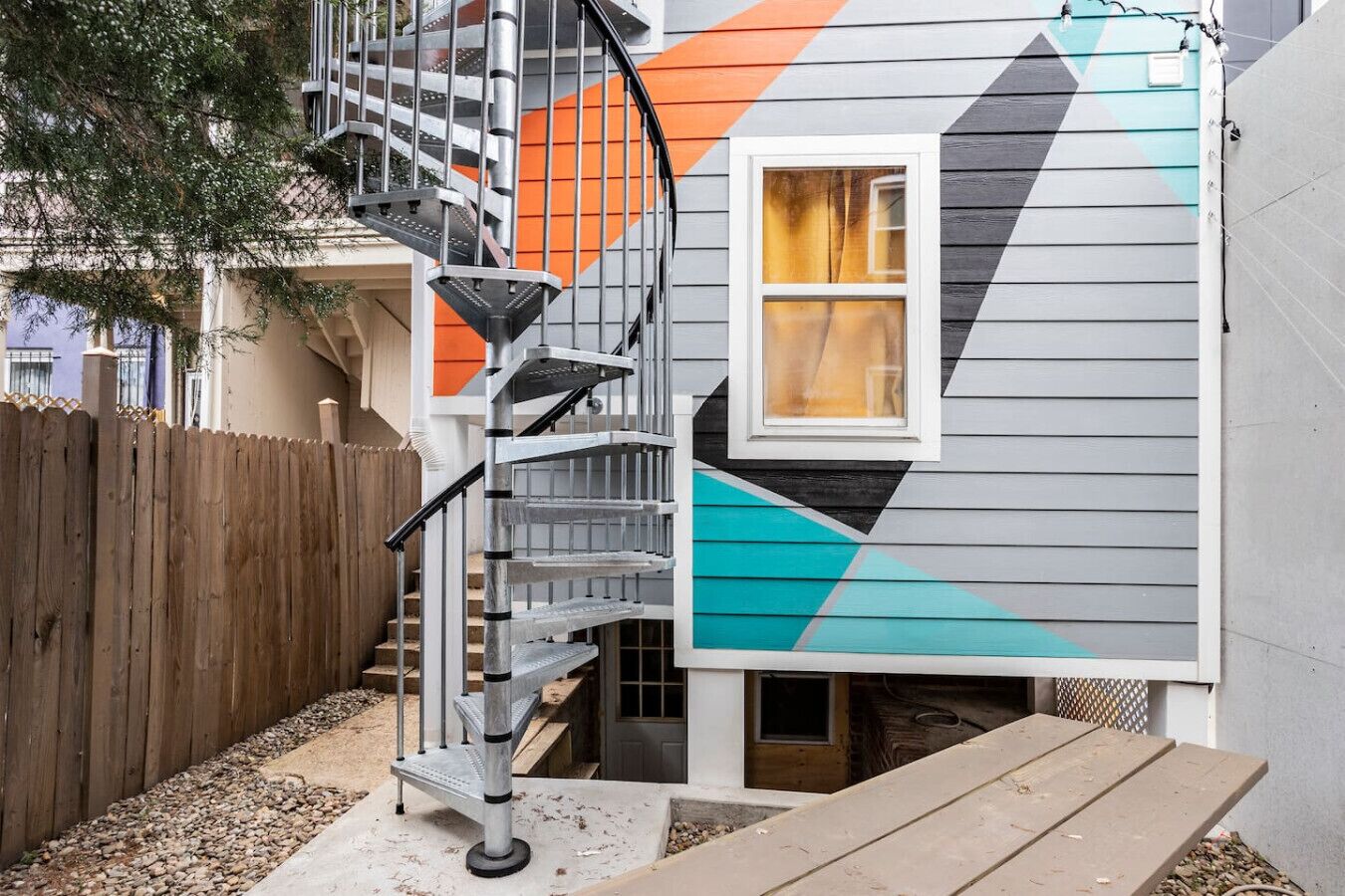 A house with a spiral staircase leading to a second-floor landing.