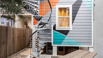 A house with a spiral staircase leading to a second-floor landing.