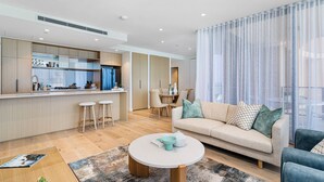 Un appartement moderne comprenant une cuisine, un coin repas et un salon.