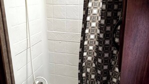 A bathroom with a shower, a sink, and a toilet. - Ample Lakeside Travel Trailer (Bridgeport)