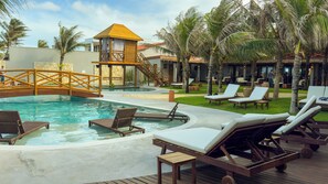 A pool area with lounge chairs, a wooden deck, and a small tower structure. - Carnaúba Hotel Boutique (Aquiraz)