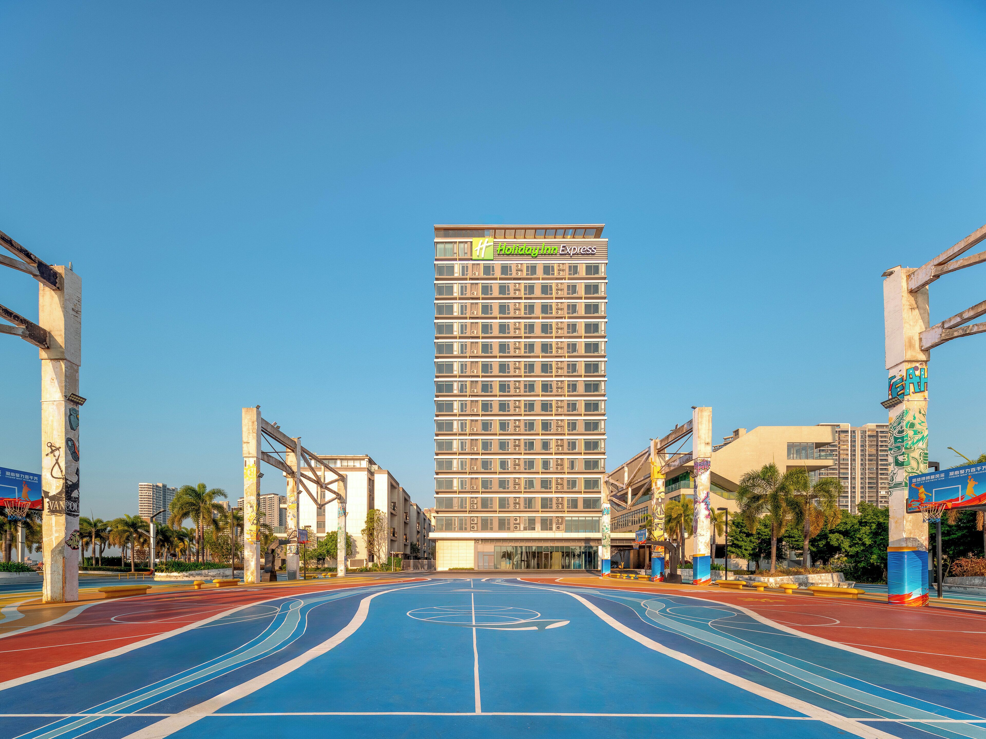 A high-rise building with a prominent sign for 'Holiday Inn Express'.