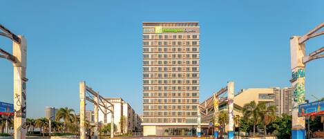 A high-rise building with a prominent sign for 'Holiday Inn Express'.