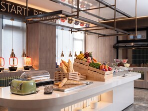 A breakfast bar with a toaster, bread, fruits, and beverages. - Holiday Inn Express Changzhou Henglin by IHG (Changzhou)