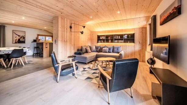 A modern living room with a wooden ceiling, a sofa set, a coffee table, and a TV mounted on the wall. - 1st floor, view village, balcony, fireplace or stove, parking, tv, ski locker, 97m², Morzine (Morzine)