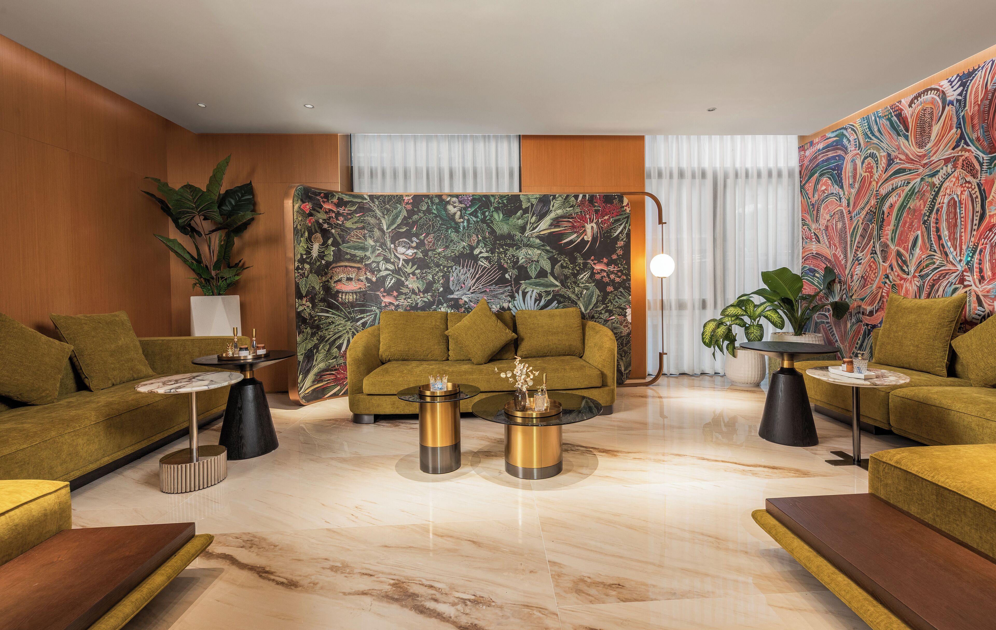 A modern living room with a sofa set, two coffee tables, and decorative plants.