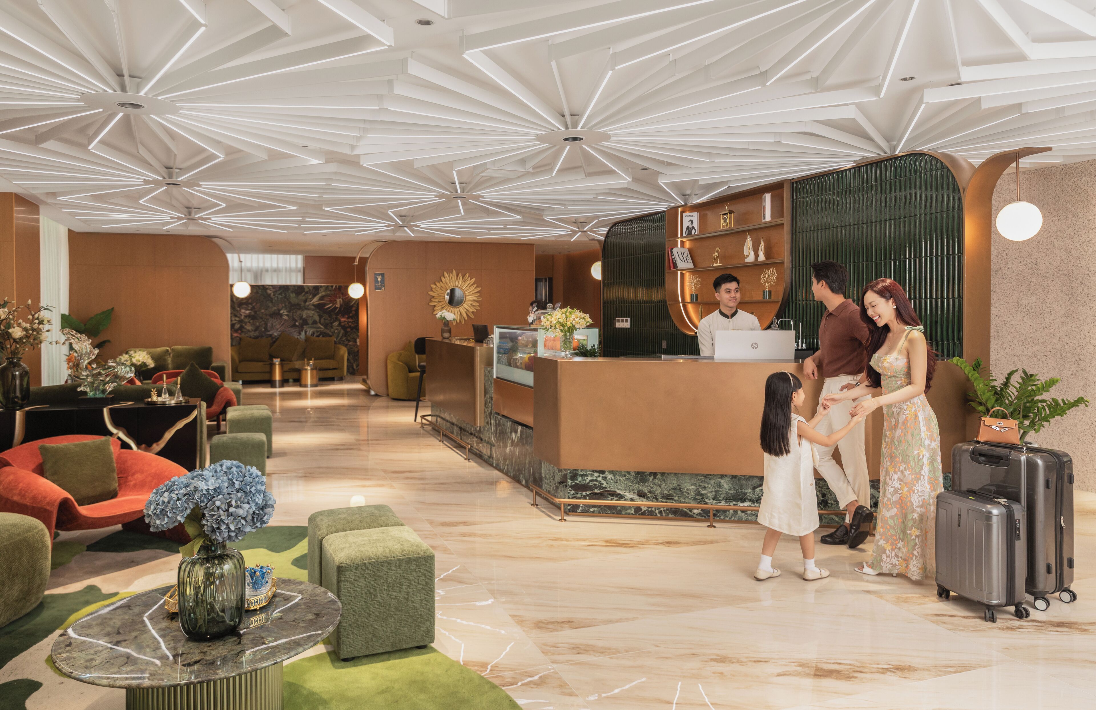 Una hall d'albergo con reception, area salotto e un moderno design del soffitto.
