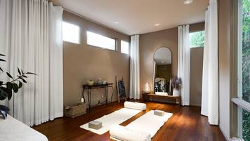 Relax in a serene space with a yoga mat, a small table, and a mirror.