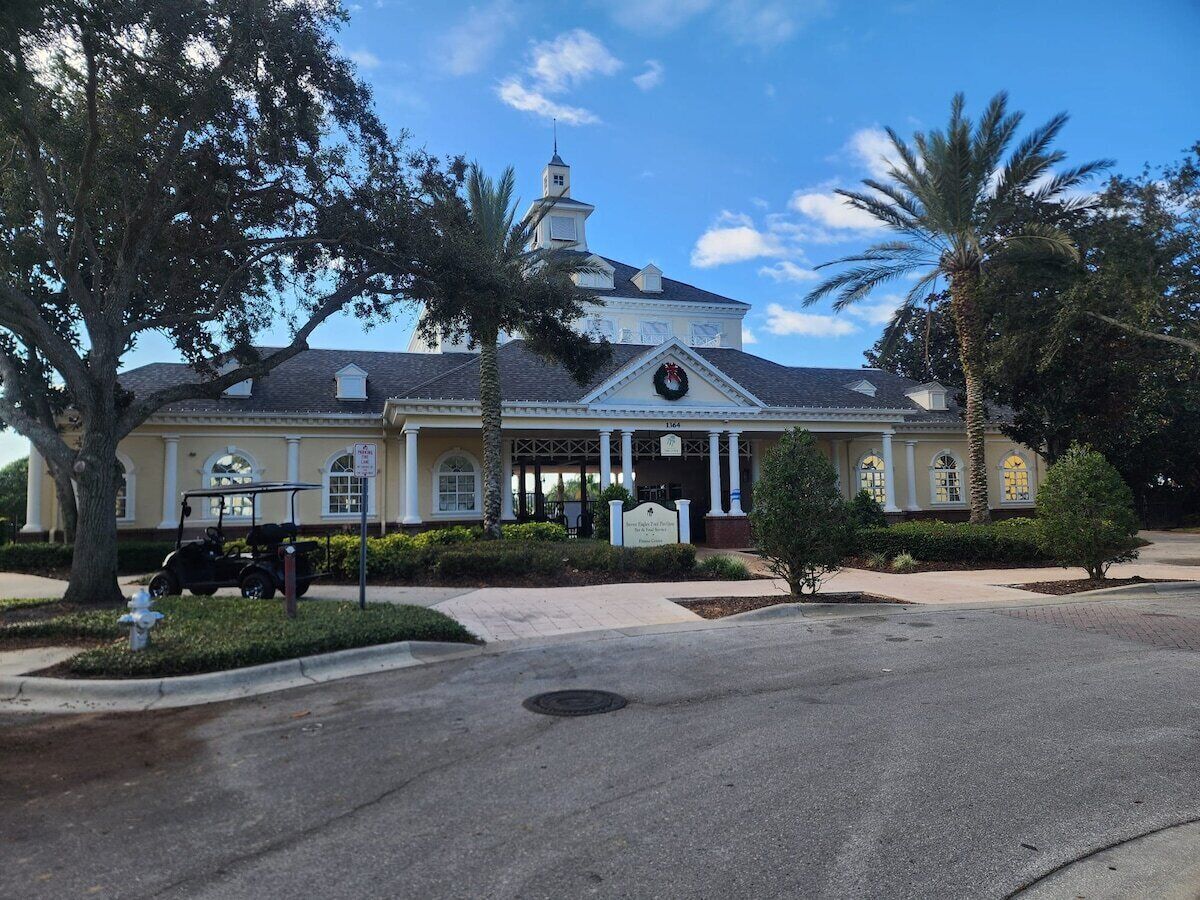 A building with a central entrance, columns, and a clock.