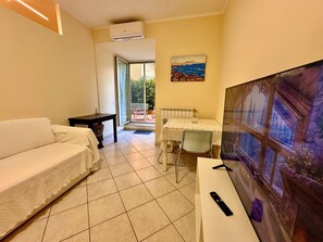 Exclusive Apartment, City View | Living area | Flat-screen TV