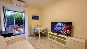 Exclusive Apartment, City View | Living area | Flat-screen TV