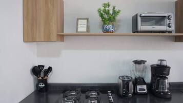 Microwave, coffee/tea maker, blender, cookware/dishes/utensils