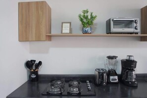 Microwave, coffee/tea maker, blender, cookware/dishes/utensils