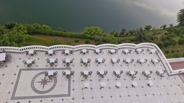 A terrace with outdoor seating and a decorative emblem.