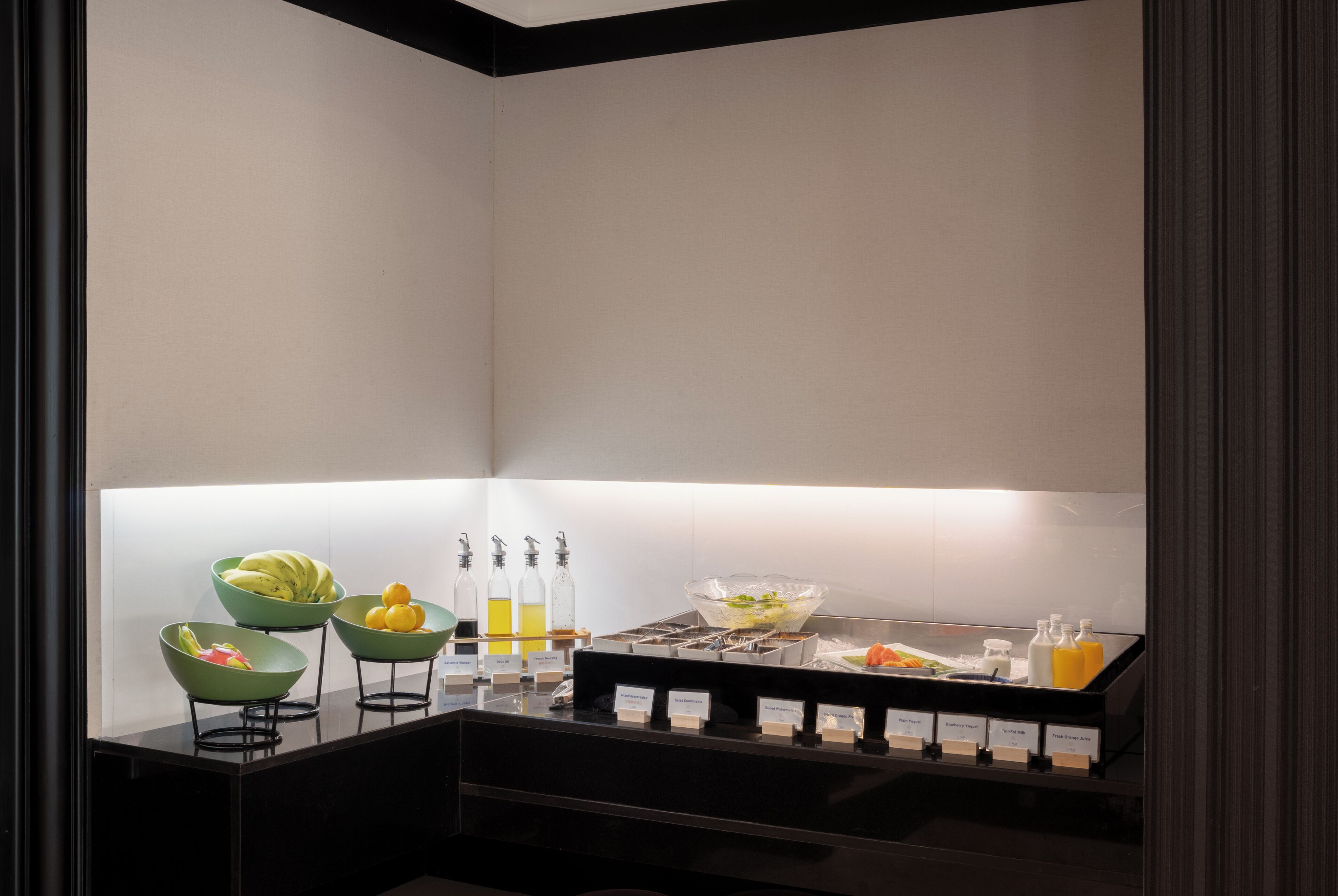A breakfast bar with various food items and beverages.